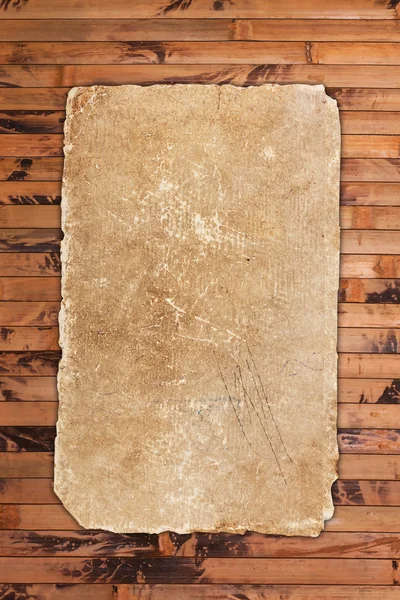 Papel velho desgastado e rasgado em madeira — Fotografia de Stock