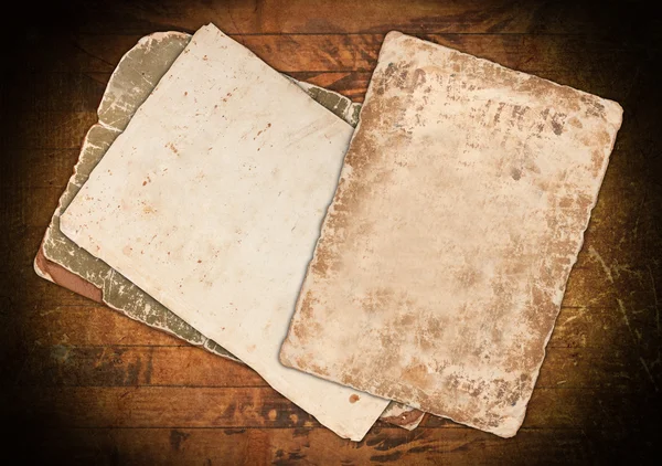 Faded old papers on a wooden background — Stock Photo, Image
