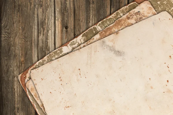 Grungy old papers on a wooden background — Stock Photo, Image