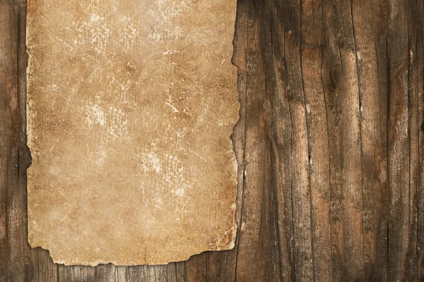 Aged paper roll on a wooden background — Stock Photo, Image