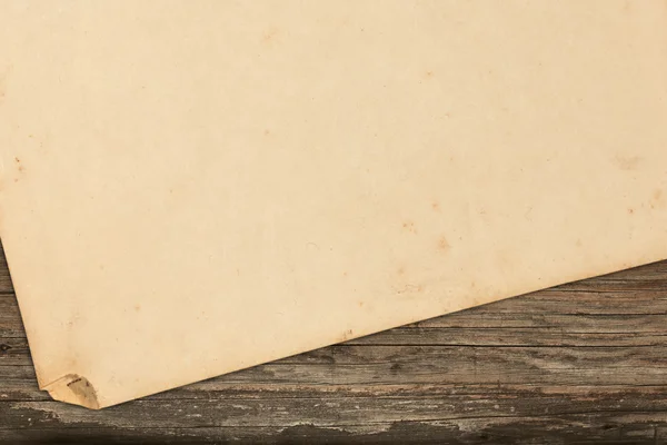 Blank old paper on a wooden background — Stock Photo, Image