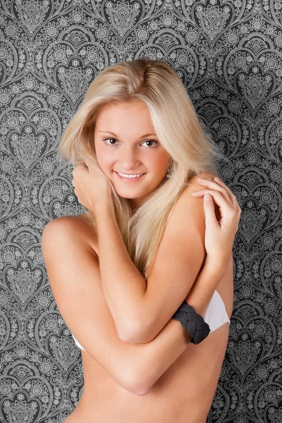 Härlig blond flicka i vit bikini leende — Stockfoto
