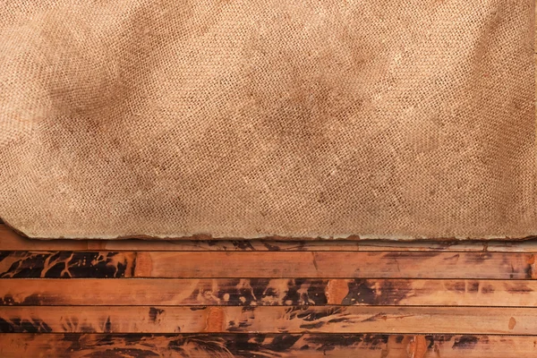 Grungy paper sheet on a wooden background — Stock Photo, Image