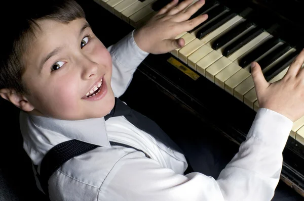 stock image Little boy and piano.