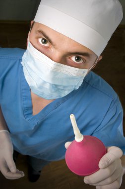 Funny doctor with a enema. clipart