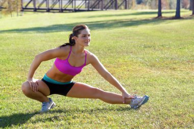 Beautiful Brunette Ahtlete Stretches Outdoors (5) clipart