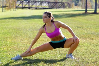 Beautiful Brunette Ahtlete Stretches Outdoors (6) clipart