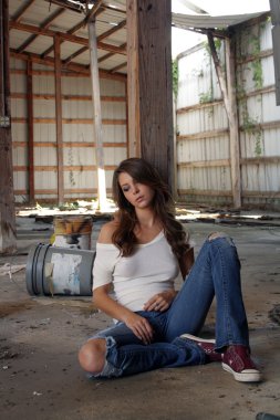 Beautiful Brunette Sitting in an Abandoned Warehouse (1) clipart