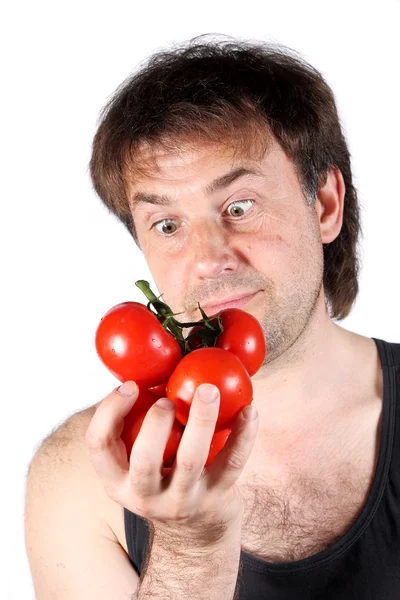 Mężczyzna patrząc na pomidory na białym tle — Zdjęcie stockowe