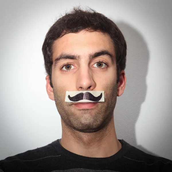 Young guy with fake moustache — Stock Photo, Image