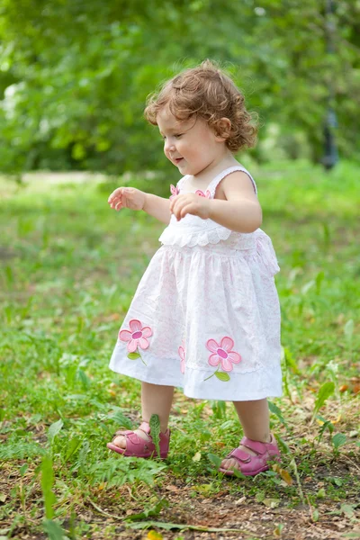 Stock image Little girl ran across green grass