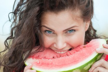 Woman in wheat field eating watermelon. Picnic. clipart