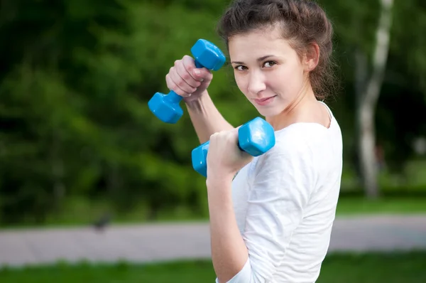 Woman doing exercise with dumbbell — Stock Photo, Image