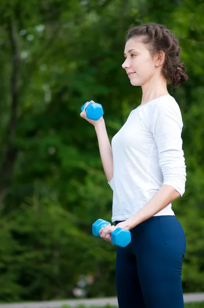 stock image Woman doing exercise with dumbbell