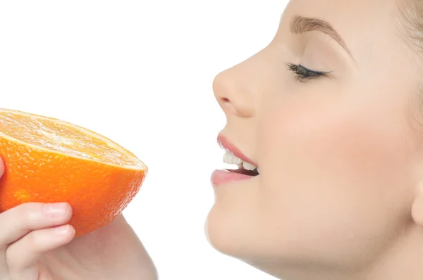 Pretty young woman with half orange — Stock Photo, Image