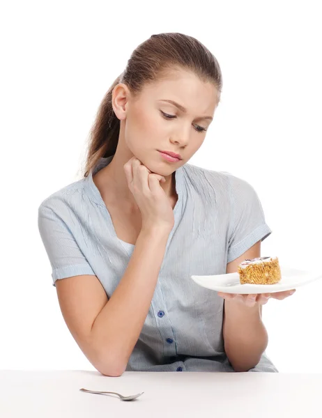 Uma jovem bonita a comer bolo. Isolados — Fotografia de Stock