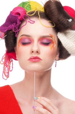 Closeup fashion woman with color face art in knitting style clipart