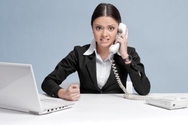 Casual business woman in office talking by phone clipart