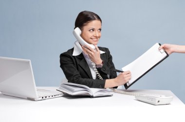 Busy business woman talking by phone clipart