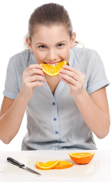 stock image Pretty young woman eating orange. Isolated