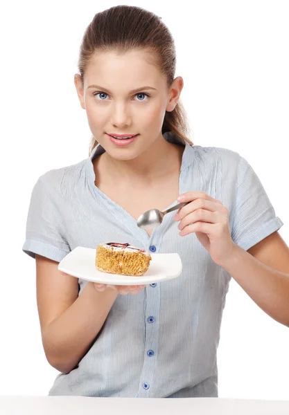 Pretty young woman eating cake. Isolated — Stock Photo, Image