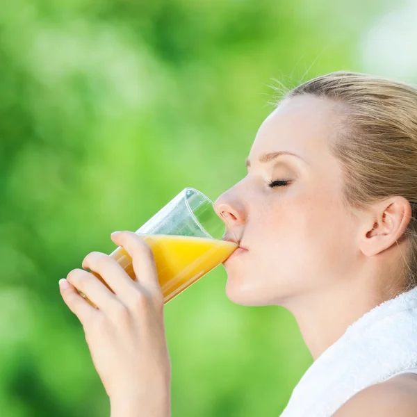 stock image Woman drinking juice after exercise