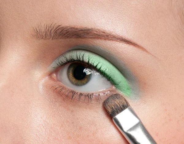 Frau trägt kosmetischen Pinsel auf Augenpartie auf — Stockfoto