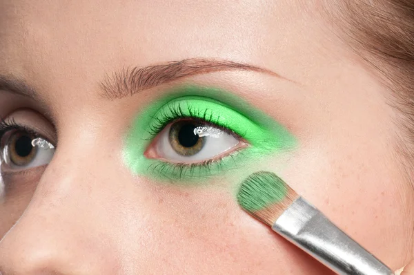 Woman applying cosmetic paint brush on eye zone — Stock Photo, Image