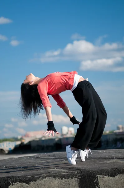 Woman dancing hip hop over blue sky — Stock Photo, Image