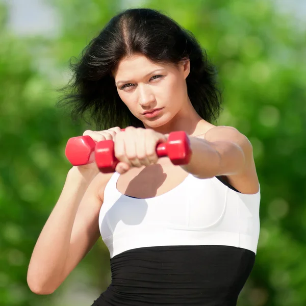 Woman doing exercise with dumbbell — Stock Photo, Image