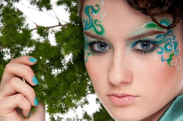 Close-up of sprite girl with faceart and plant — Stock Photo, Image