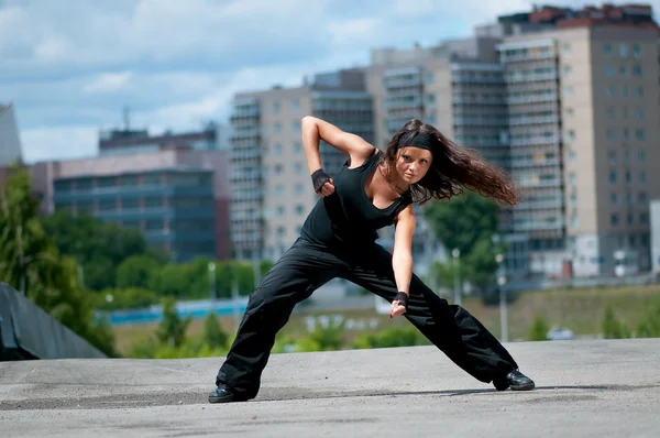 Красива дівчина танцює хіп-хоп над міським пейзажем — стокове фото
