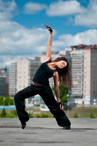 Beautiful girl dancing hip-hop over urban landscape — Stock Photo, Image