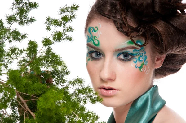Close-up of sprite girl with faceart and plant Royalty Free Stock Images