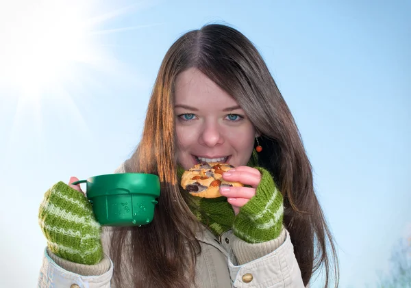 Chica en el picnic de invierno con taza de tee y galletas — Foto de Stock