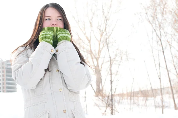 Beautiful girl in green over winter landscape — Stock Photo, Image