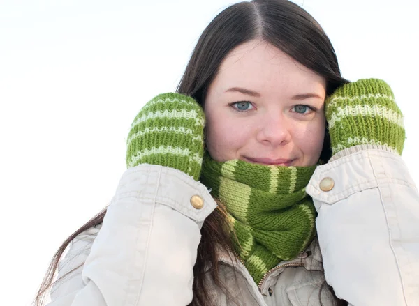 Beautiful girl in green over winter landscape — Stock Photo, Image