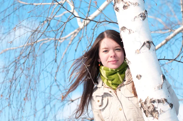 Hermosa chica en verde sobre el árbol y el cielo azul — Foto de Stock