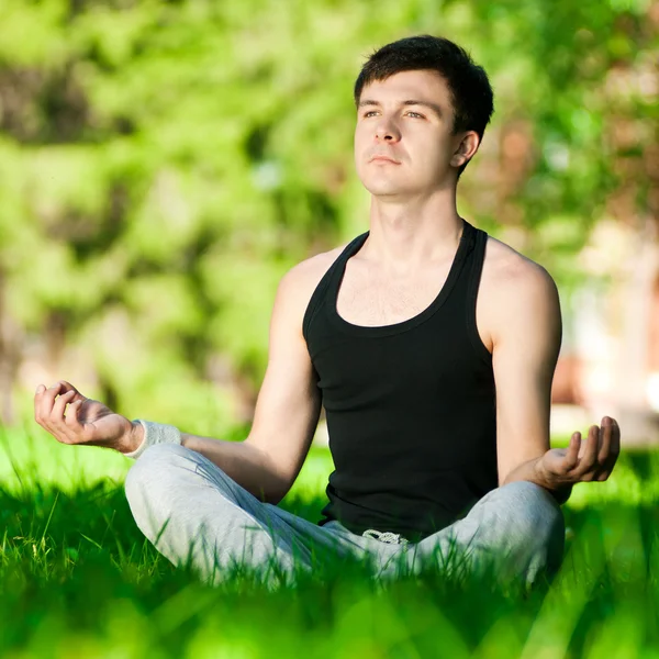 stock image A young man doing yoga exercise