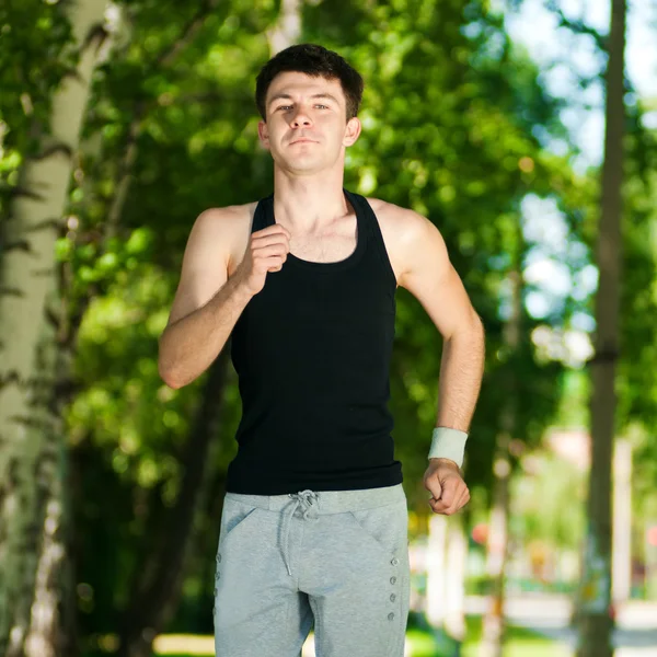 Young man jogging in park — Stock Photo, Image