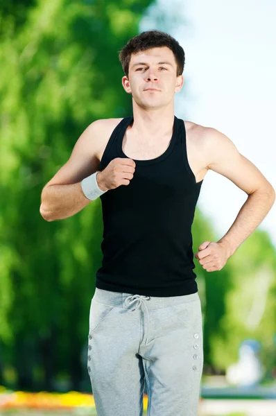 stock image Young man jogging in park