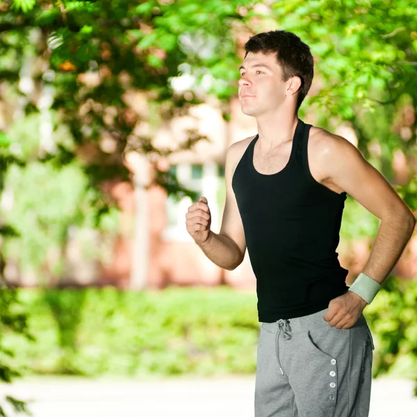 stock image Young man jogging in park