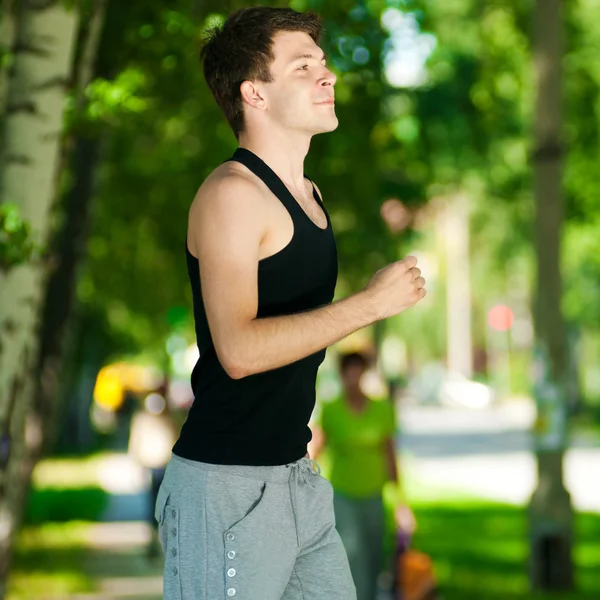 stock image Young man jogging in park