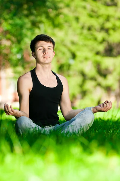A young man doing yoga exercise — Stock Photo, Image