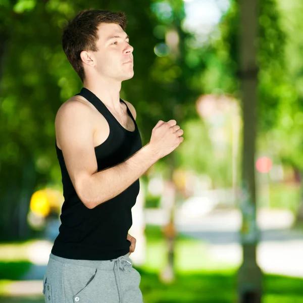 Young man jogging in park — Stock Photo, Image
