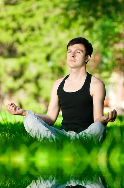 A young man doing yoga exercise — Stock Photo, Image