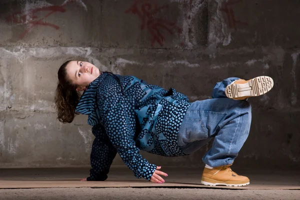 Hip hop dancer in modern style over brick wall — Stock Photo, Image