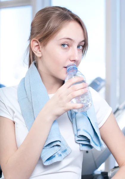 stock image Woman at the gym exercising. Run on on a machine and drink water