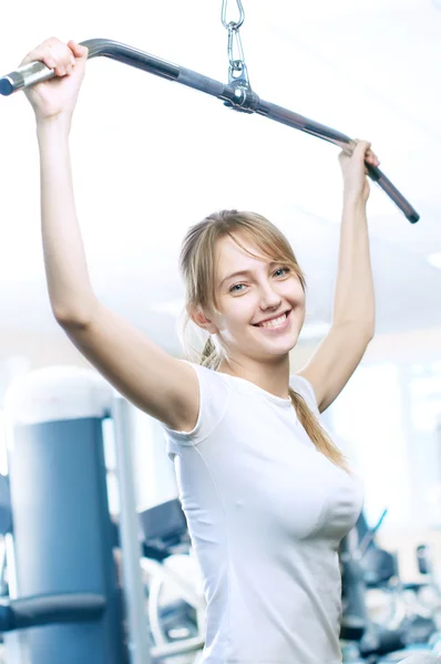 stock image Powerful casual woman lifting weights in gym