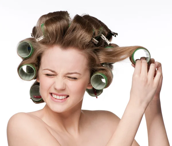 Woman curling her hair with roller — Stock Photo, Image